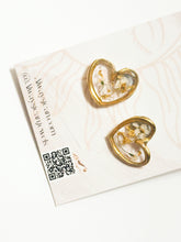 Load image into Gallery viewer, Brass hearts filled with resin and real pressed flowers.